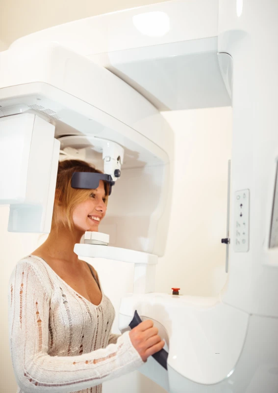 A modern dental clinic featuring a high-tech dental chair with attached equipment, a clean and bright interior.